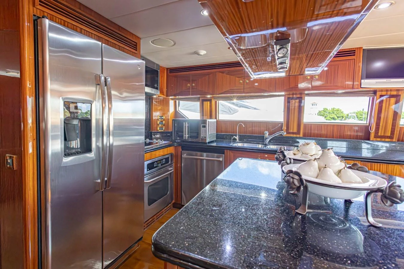 The yacht's galley features modern stainless steel appliances and elegant wood finishes. aboard MY ANGEL Yacht for Sale