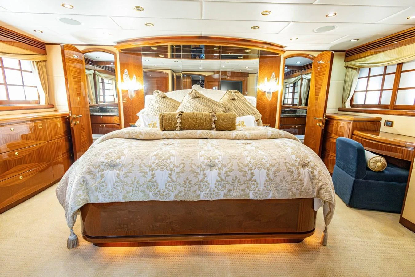The master stateroom features a luxurious bed with elegant bedding and warm wooden furnishings. aboard MY ANGEL Yacht for Sale