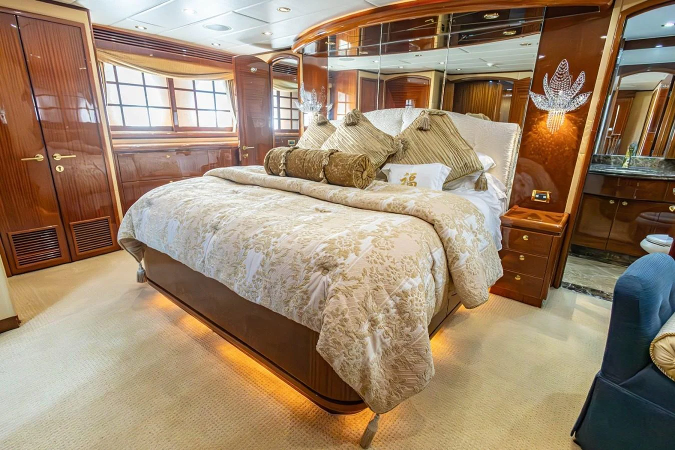 The master stateroom features a luxurious bed with elegant bedding and warm wood accents. aboard MY ANGEL Yacht for Sale