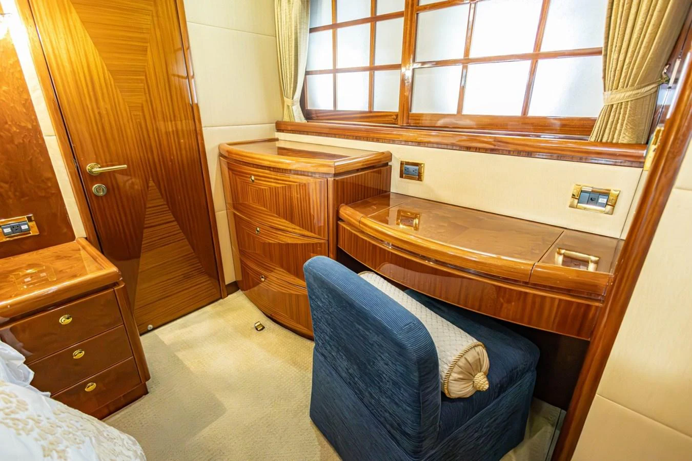 The stateroom features elegant wooden cabinetry and a comfortable seating area. aboard MY ANGEL Yacht for Sale