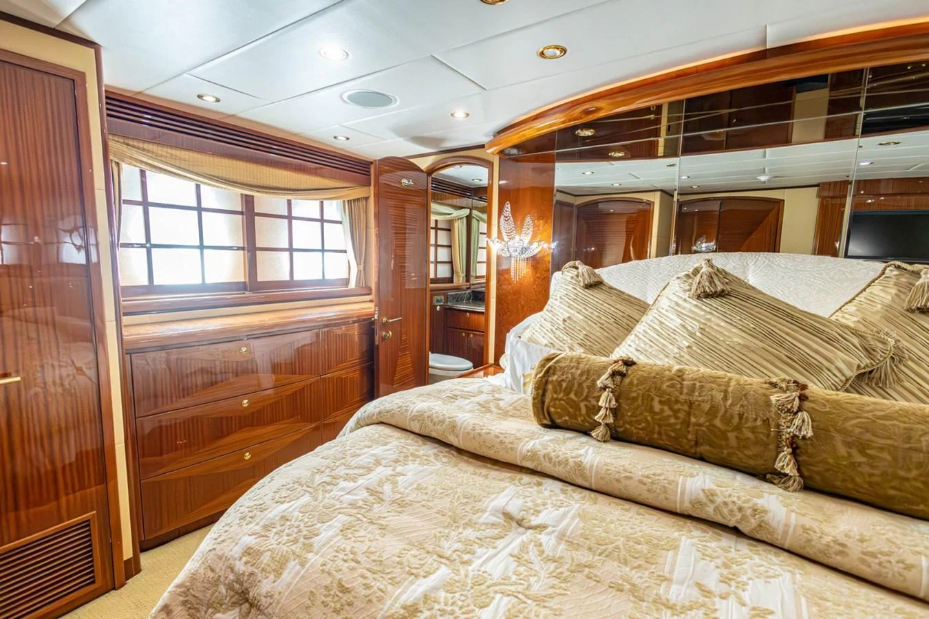 The master stateroom features luxurious bedding and elegant wood finishes, creating a warm and inviting atmosphere. aboard MY ANGEL Yacht for Sale