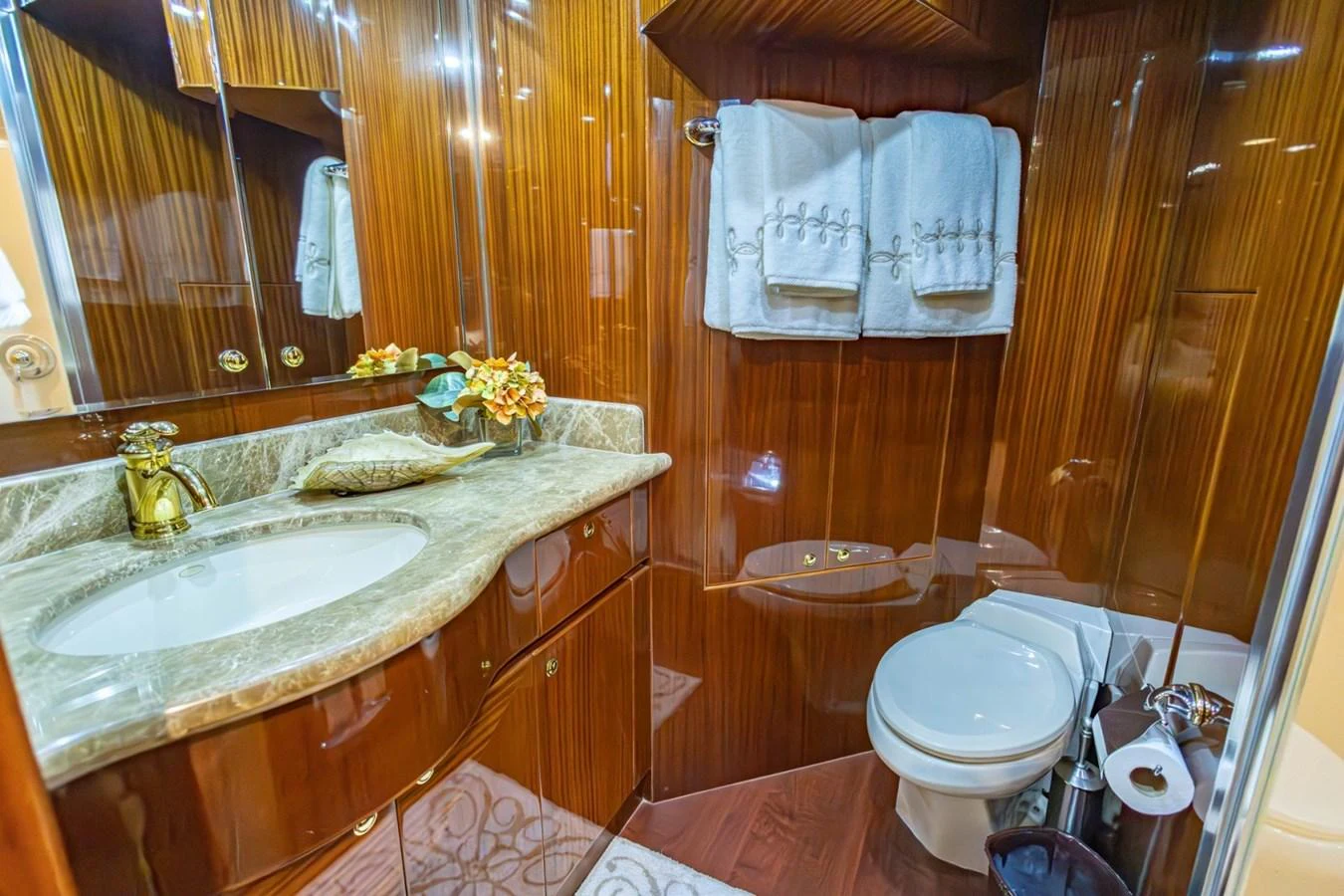 The yacht's bathroom features luxurious wood paneling and elegant fixtures. aboard MY ANGEL Yacht for Sale