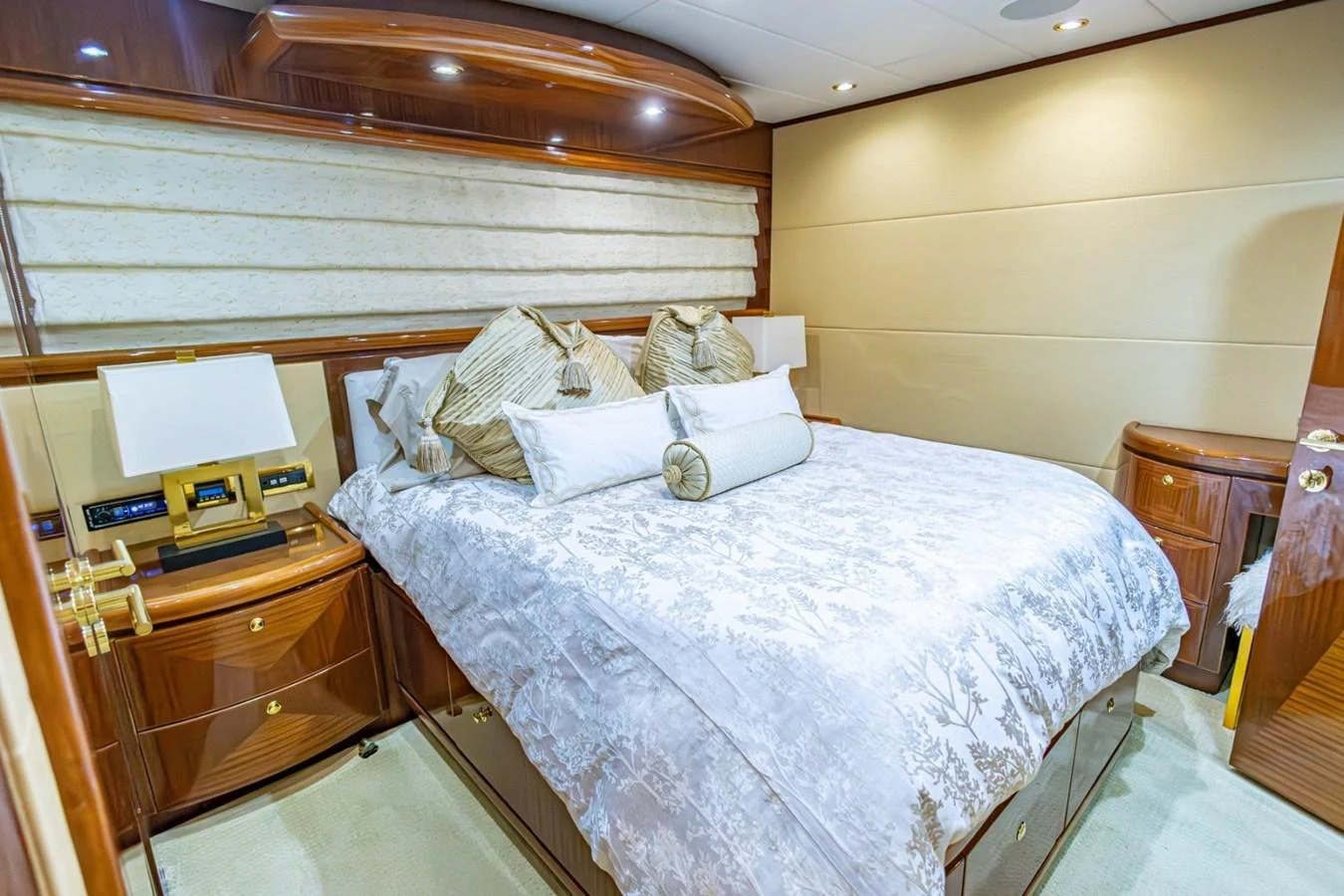 The stateroom features a luxurious bed with elegant bedding and warm wood accents. aboard MY ANGEL Yacht for Sale