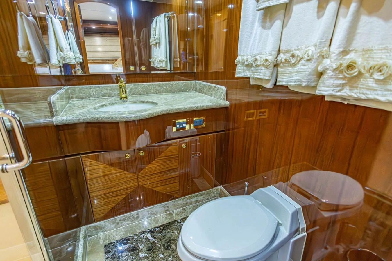 The yacht's bathroom features luxurious wood paneling and elegant fixtures. aboard MY ANGEL Yacht for Sale