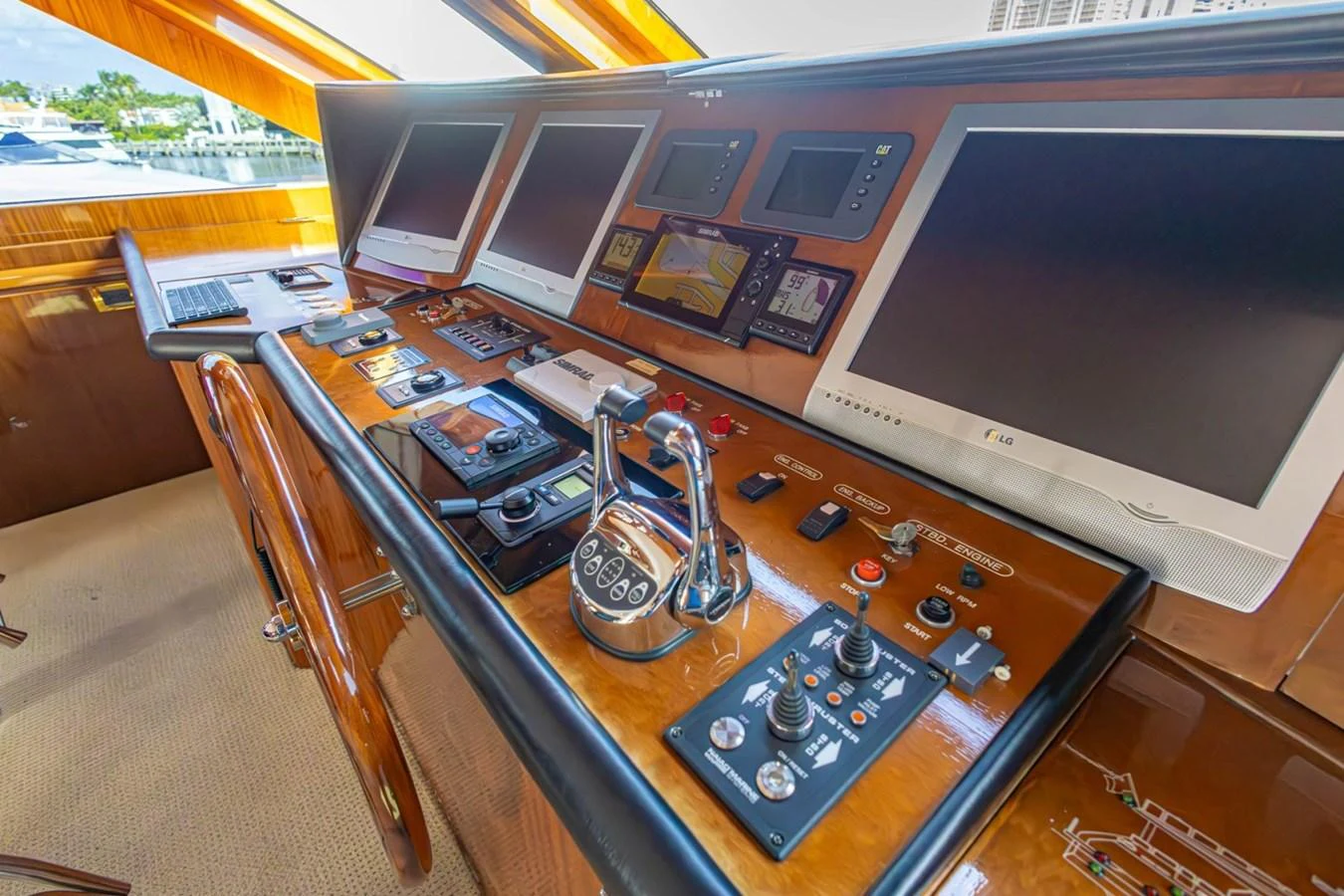 The helm station features advanced navigation and control systems with a luxurious wood finish. aboard MY ANGEL Yacht for Sale