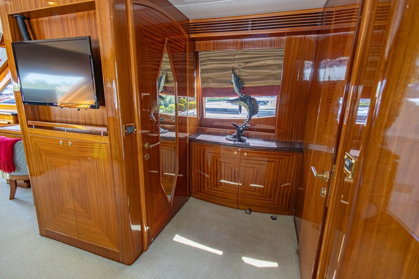 The yacht's interior features luxurious wood paneling and a stylish decor piece. aboard MY ANGEL Yacht for Sale