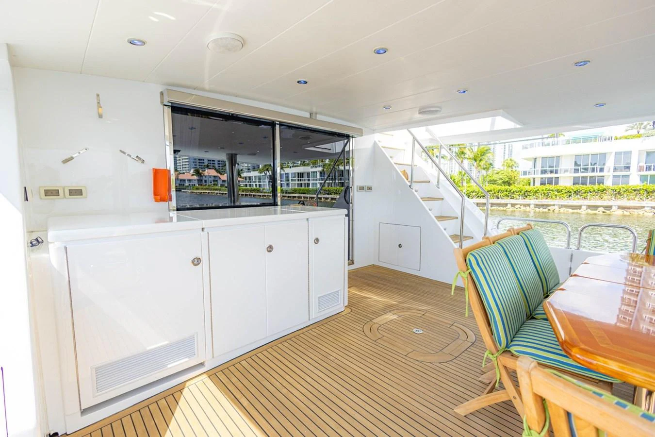 The aft deck features a spacious seating area with a dining table and easy access to the upper deck. aboard MY ANGEL Yacht for Sale
