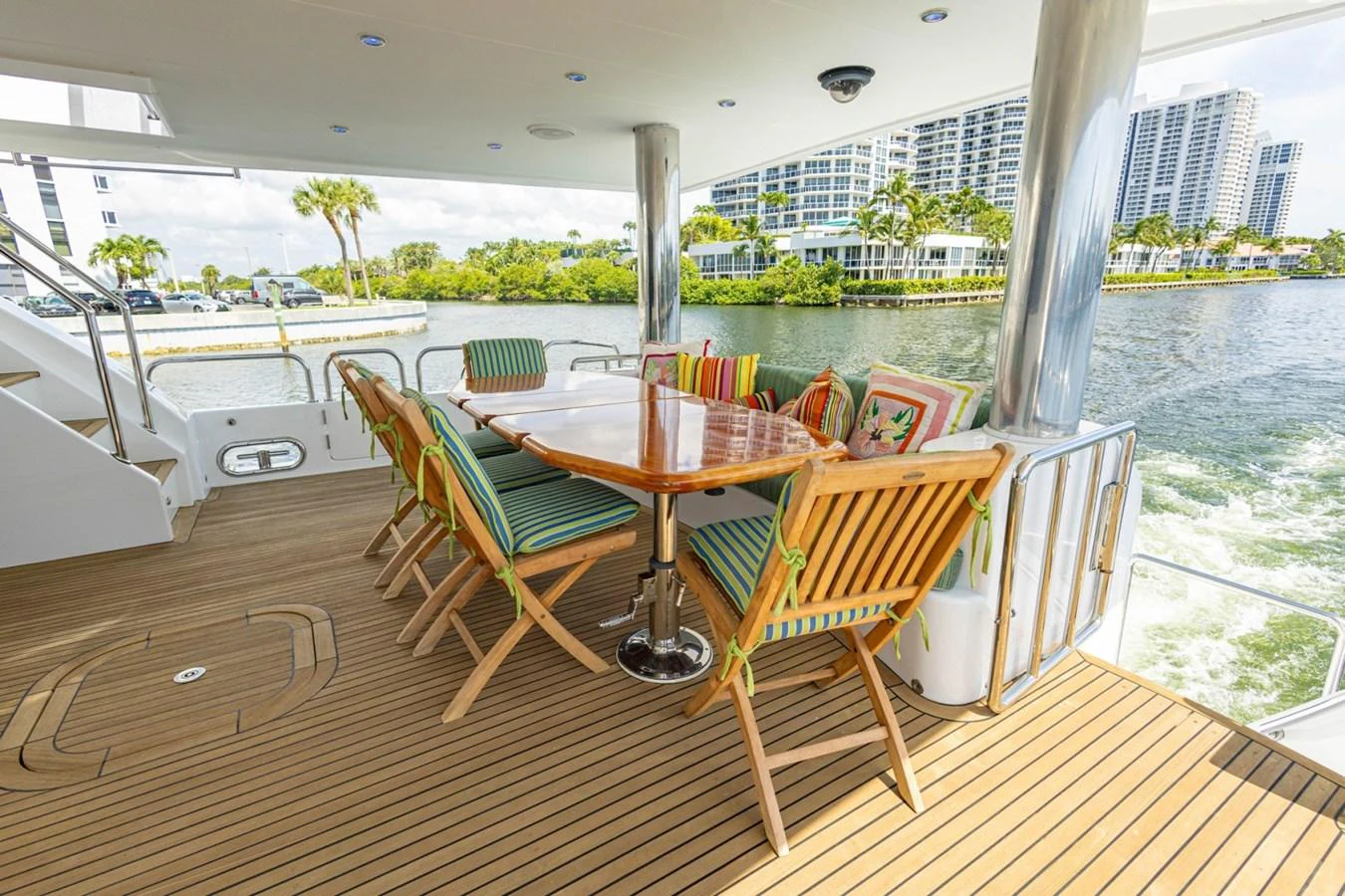 The aft deck features a spacious dining area with a polished wooden table and comfortable chairs, perfect for alfresco dining. aboard MY ANGEL Yacht for Sale