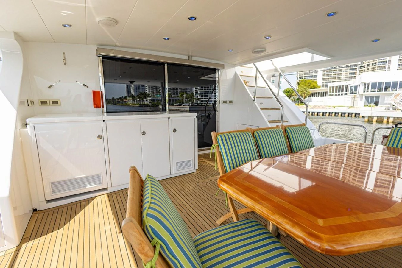 The aft deck features a spacious dining area with a polished wooden table and comfortable seating, perfect for alfresco dining. aboard MY ANGEL Yacht for Sale