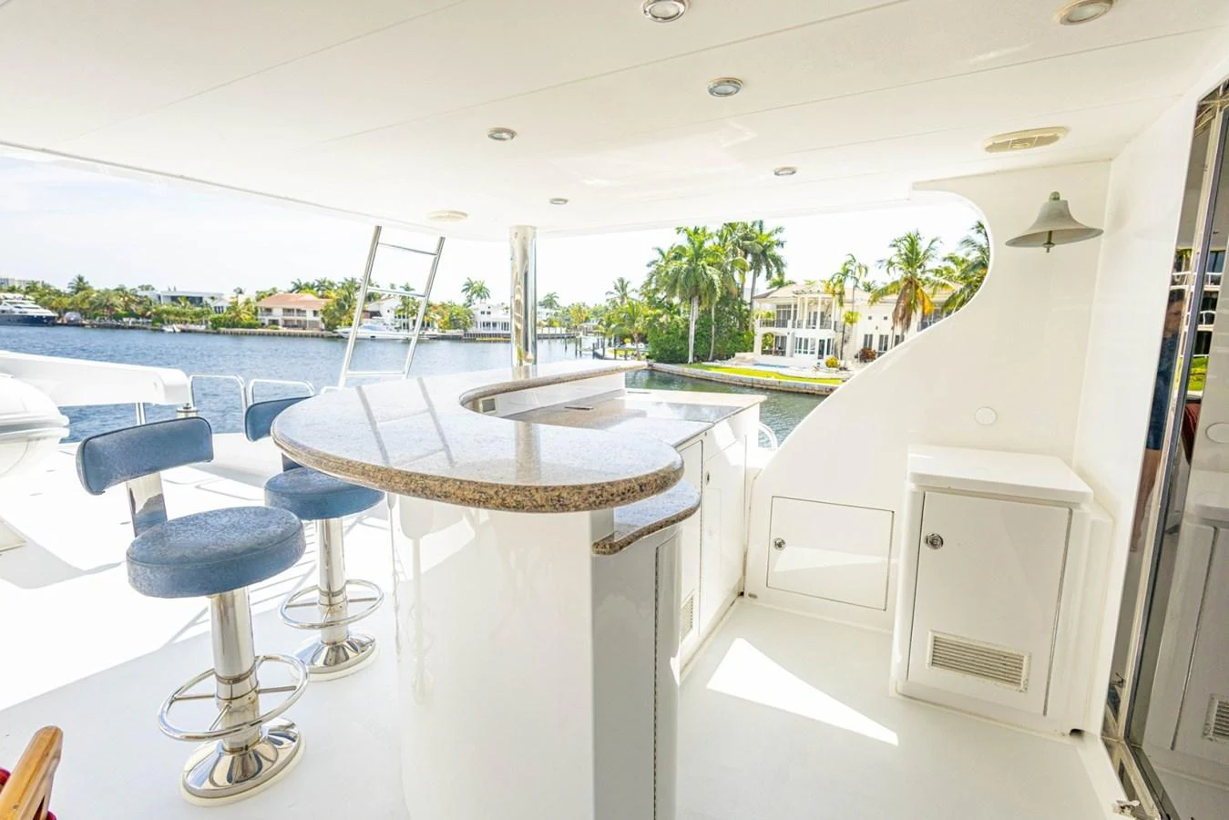 The yacht features a stylish bar area with a scenic view of the water and surrounding properties. aboard MY ANGEL Yacht for Sale