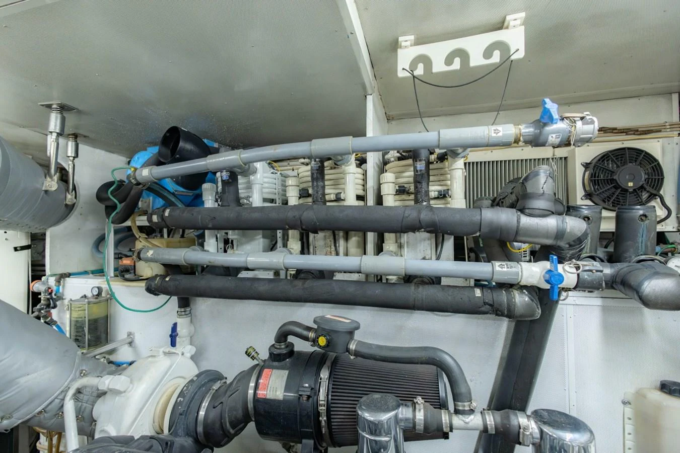 The image showcases the intricate details of the yacht's engine room with various pipes and machinery. aboard MY ANGEL Yacht for Sale