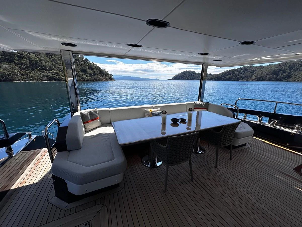 The aft deck offers a spacious and comfortable dining area with stunning views of the surrounding waters. aboard ALEX10 Yacht for Sale