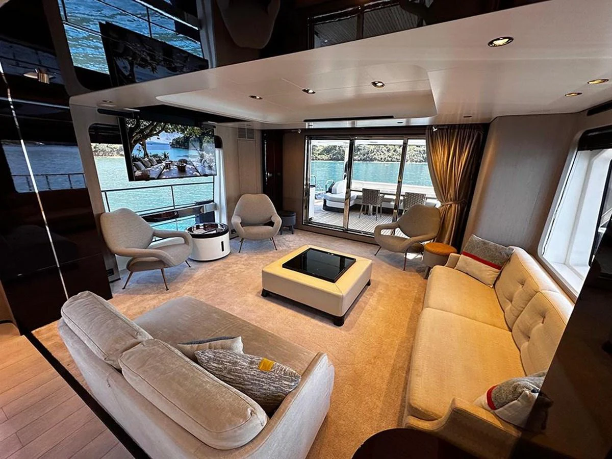 The salon offers a spacious and elegant seating area with large windows providing stunning views. aboard ALEX10 Yacht for Sale