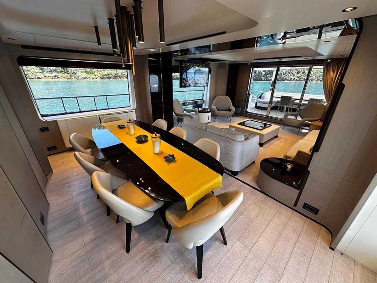 The spacious salon features a stylish dining area and a comfortable lounge with panoramic windows offering stunning views. aboard ALEX10 Yacht for Sale