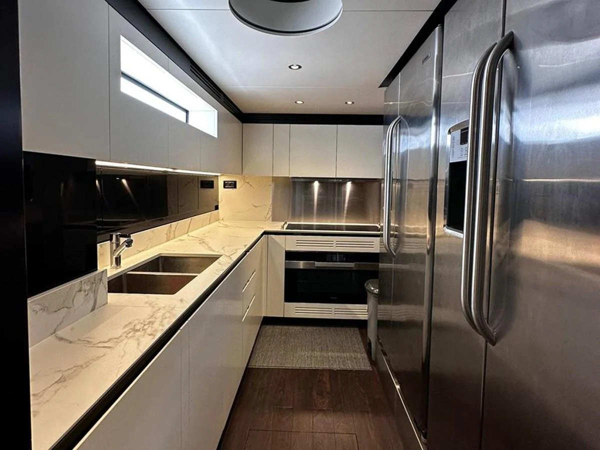 The galley features sleek modern appliances and elegant marble countertops. aboard ALEX10 Yacht for Sale