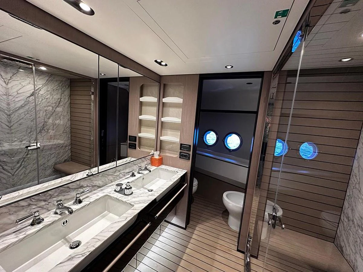 A luxurious yacht bathroom featuring a marble countertop and modern fixtures. aboard ALEX10 Yacht for Sale