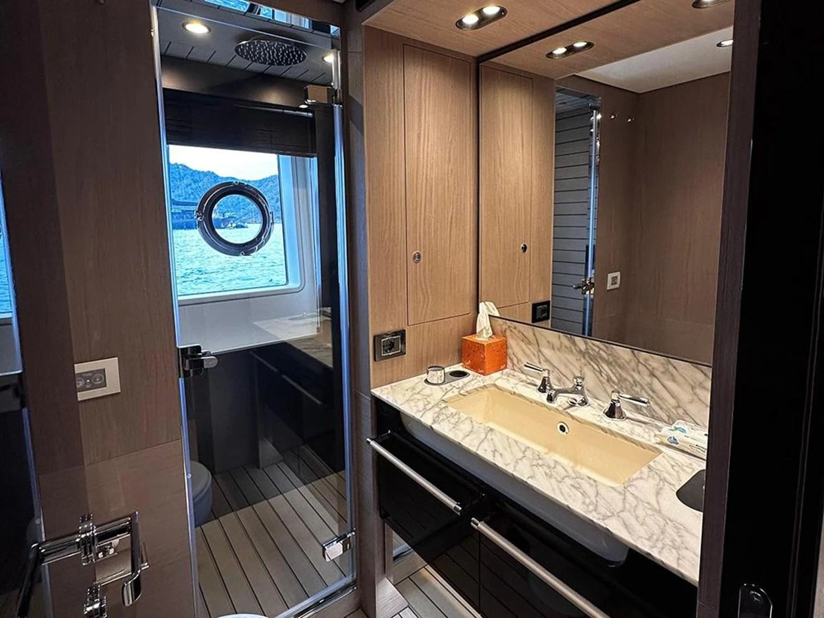 A luxurious yacht bathroom featuring a marble countertop and modern fixtures. aboard ALEX10 Yacht for Sale