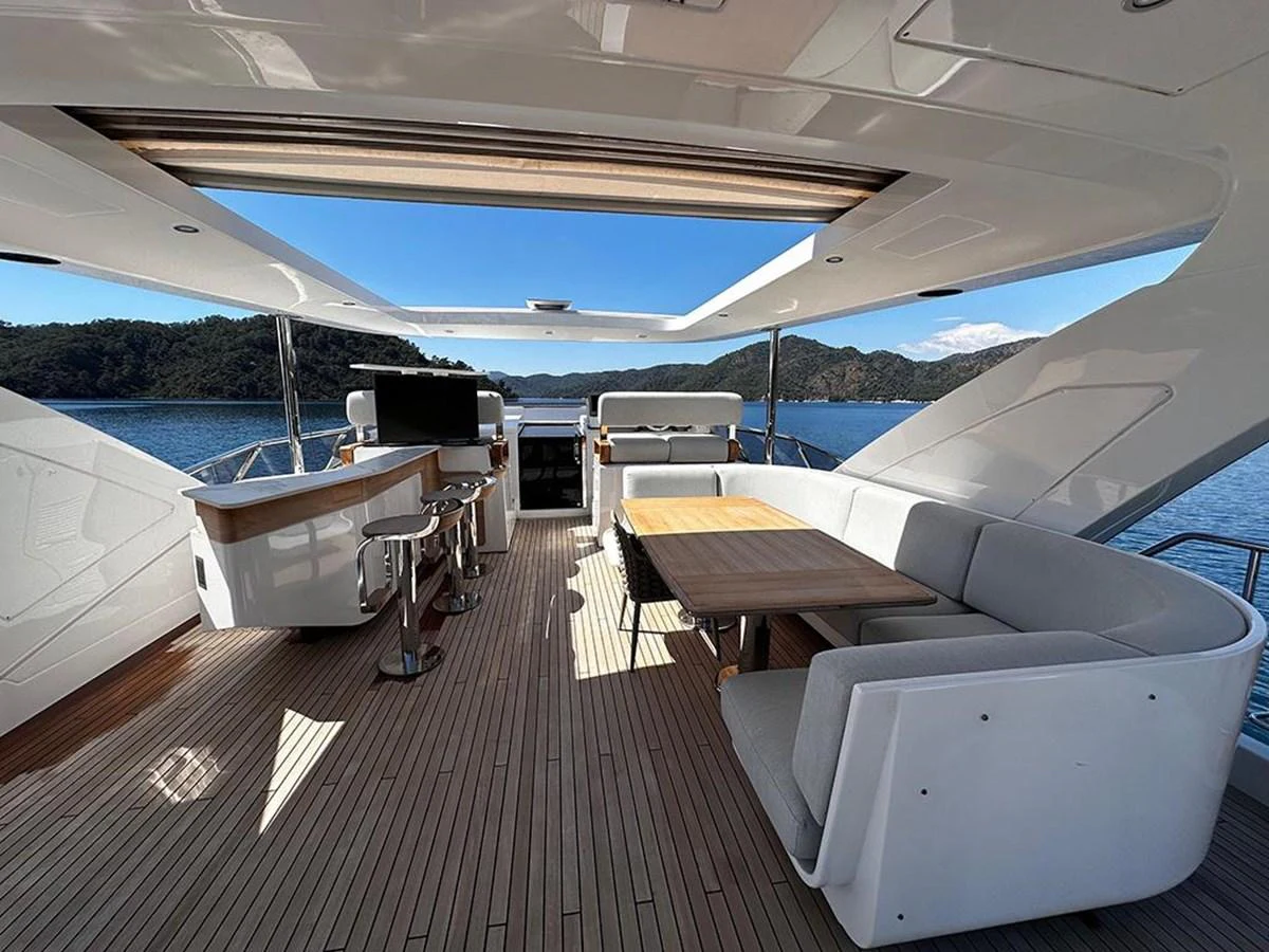The flybridge offers a spacious and elegant area for dining and relaxation with stunning views. aboard ALEX10 Yacht for Sale