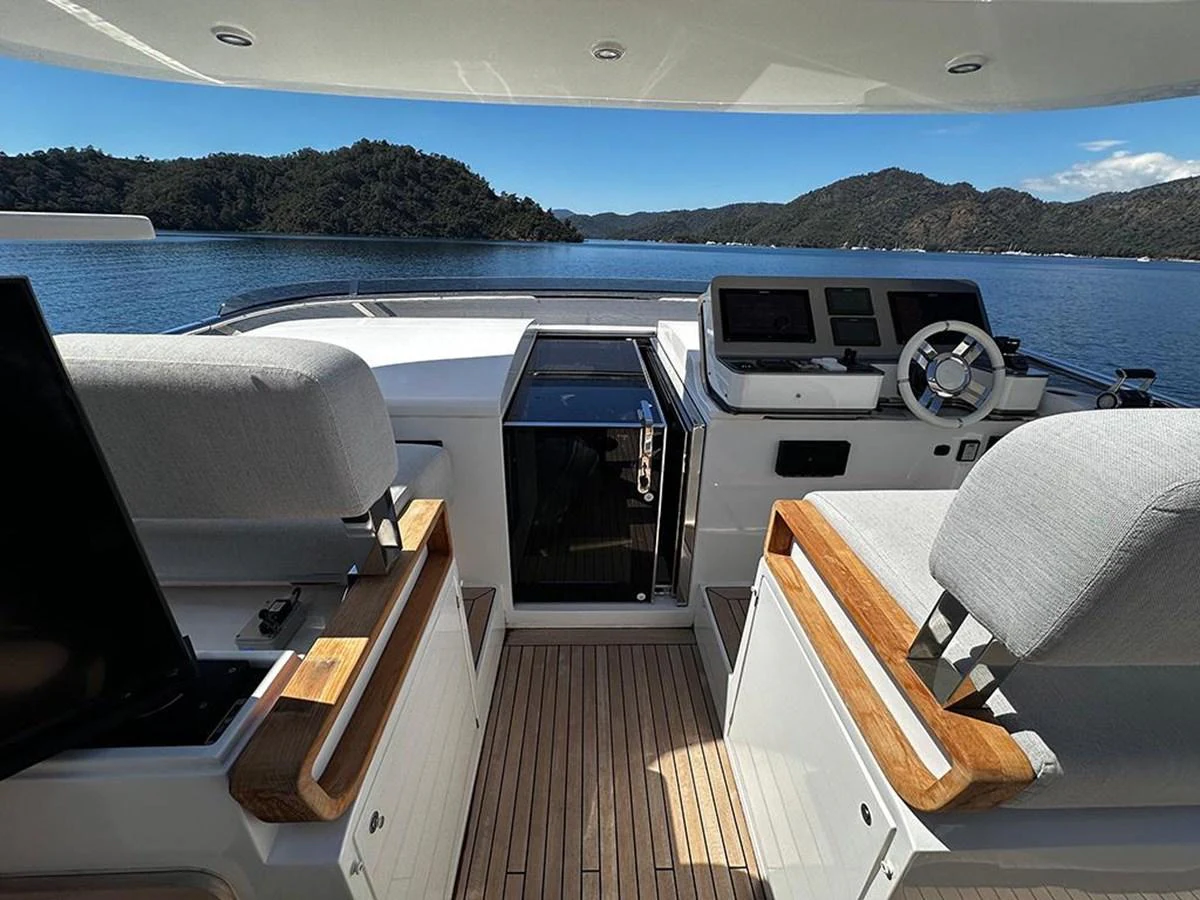 The helm area offers a commanding view with modern navigation equipment and comfortable seating. aboard ALEX10 Yacht for Sale