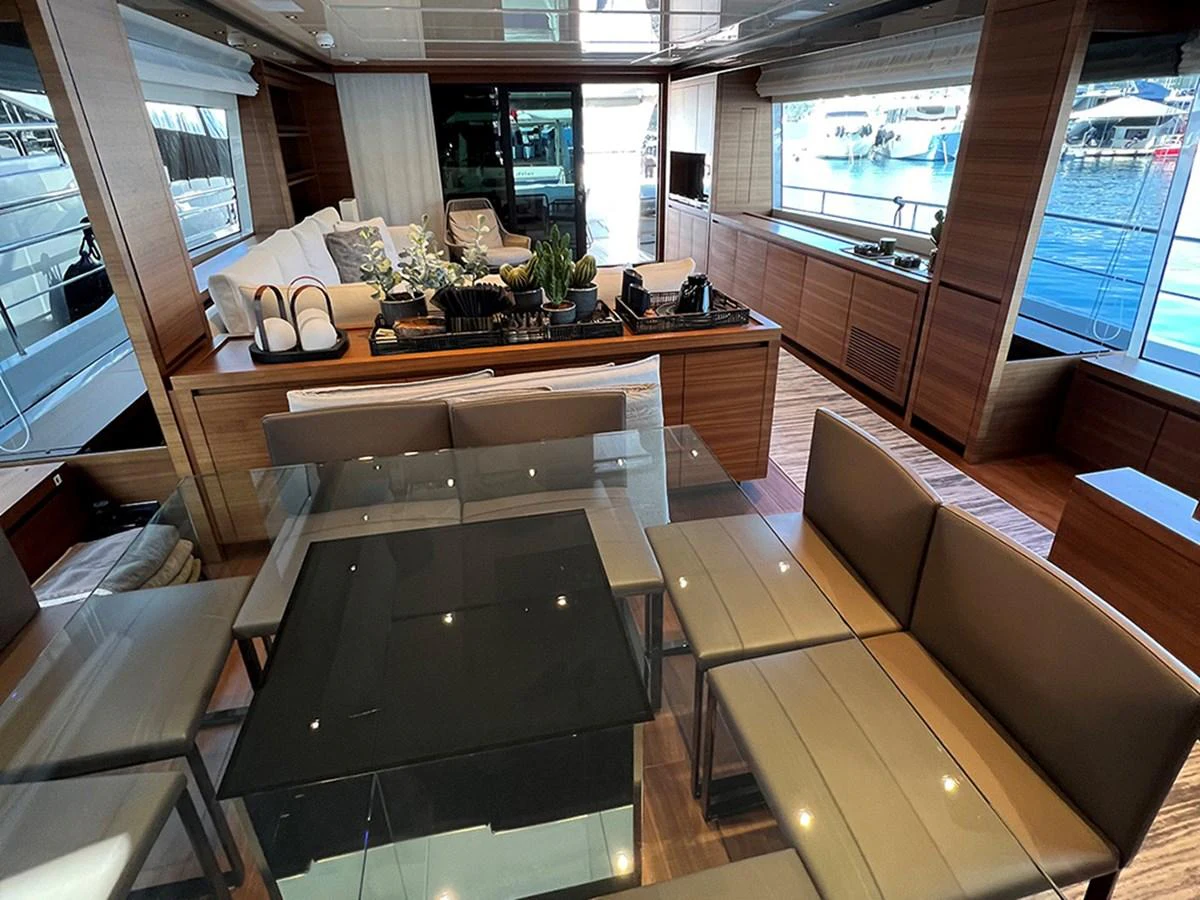 The salon features a modern and elegant design with ample seating and large windows for natural light. aboard LA ISLA Yacht for Sale