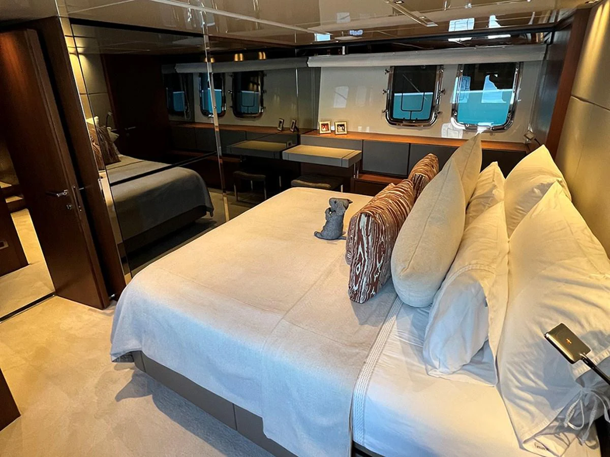 The master stateroom features a luxurious bed with plush pillows and elegant decor, offering a serene retreat. aboard LA ISLA Yacht for Sale