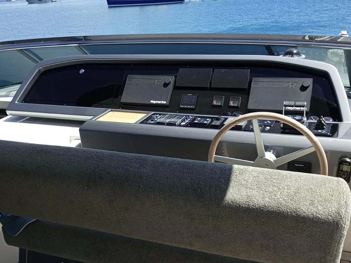 The helm station offers a commanding view with modern navigation equipment and a comfortable seating area. aboard LA ISLA Yacht for Sale