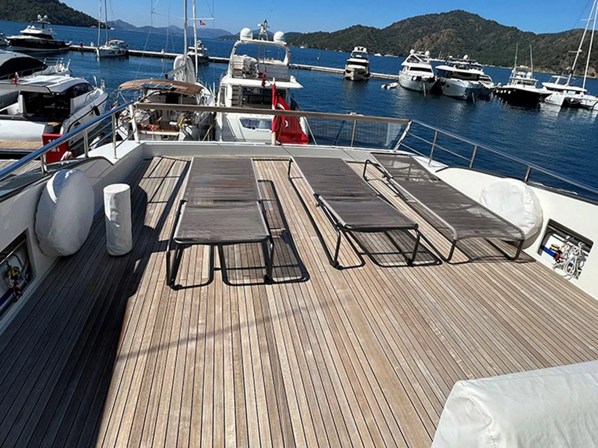 The sundeck offers a relaxing space with sun loungers and a beautiful view of the marina. aboard LA ISLA Yacht for Sale