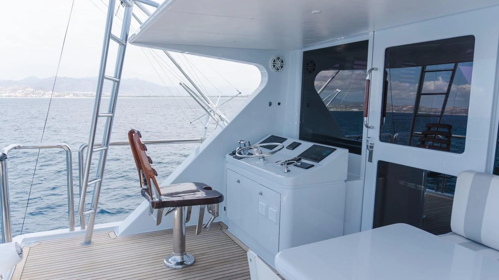 The yacht's helm station offers a sleek and modern design with advanced navigation equipment and comfortable seating. aboard AUSSIE RULES Yacht for Sale