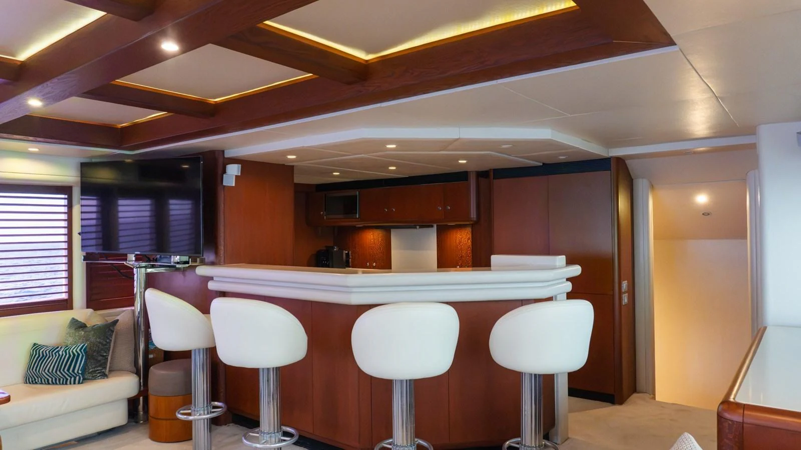 The yacht's interior features a stylish bar area with modern seating and elegant wood finishes. aboard AUSSIE RULES Yacht for Sale