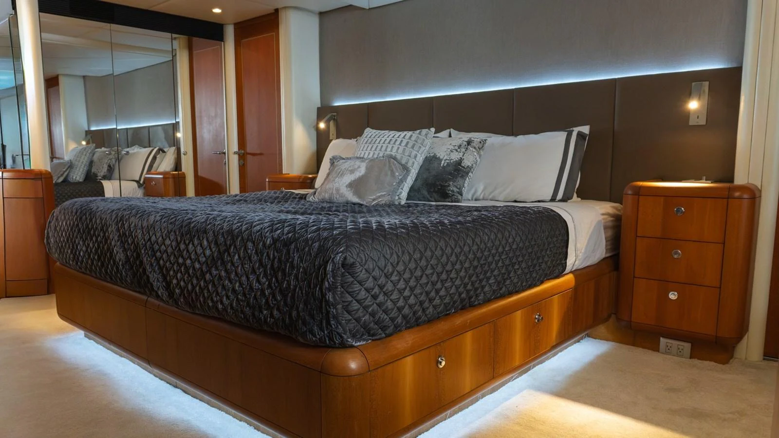 The master stateroom features a luxurious bed with elegant bedding and ambient lighting. aboard AUSSIE RULES Yacht for Sale