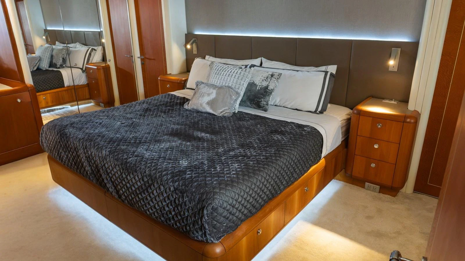 The master stateroom features a luxurious bed with elegant bedding and warm wood accents. aboard AUSSIE RULES Yacht for Sale