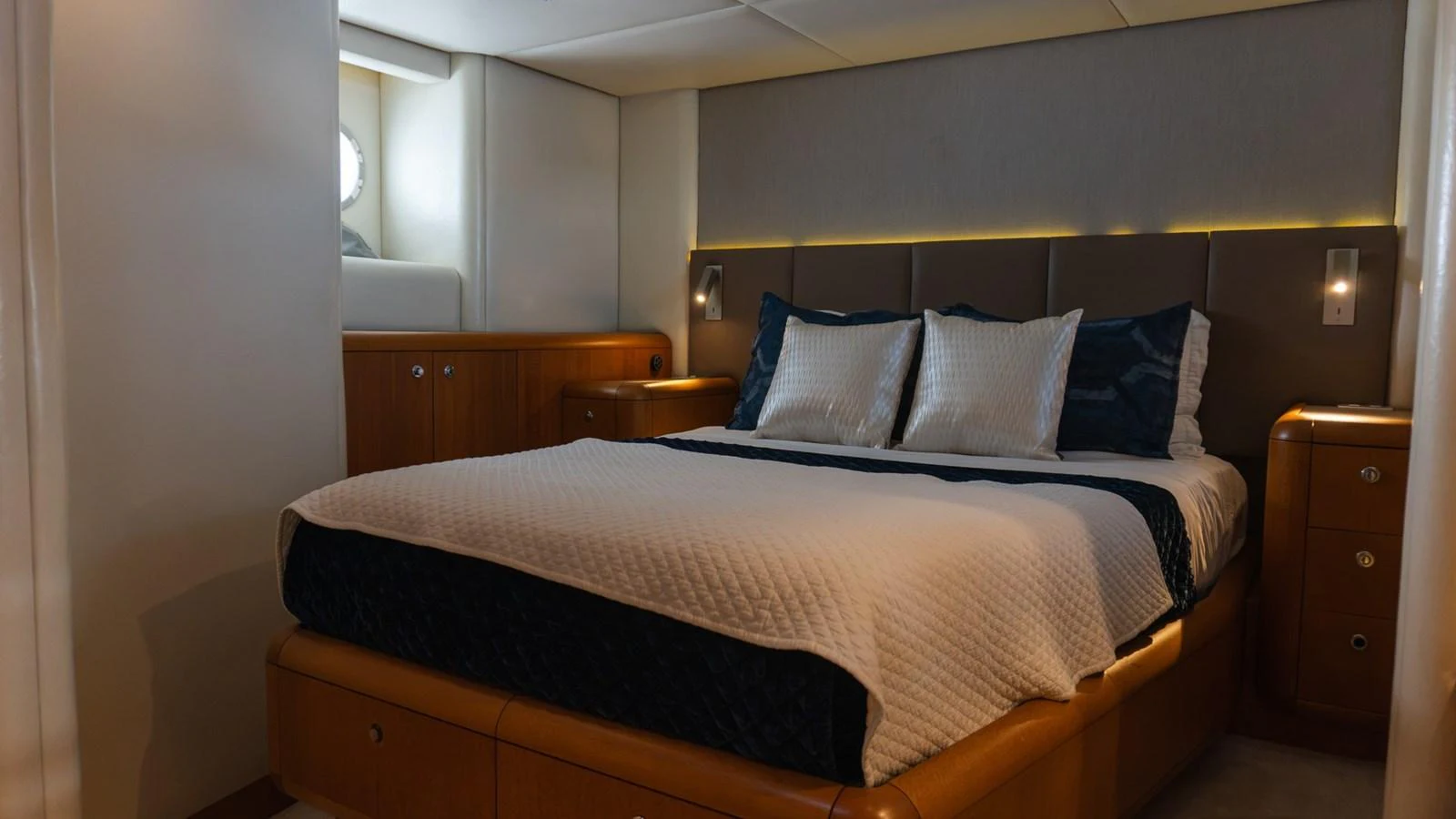 The stateroom features a luxurious bed with elegant bedding and ambient lighting. aboard AUSSIE RULES Yacht for Sale