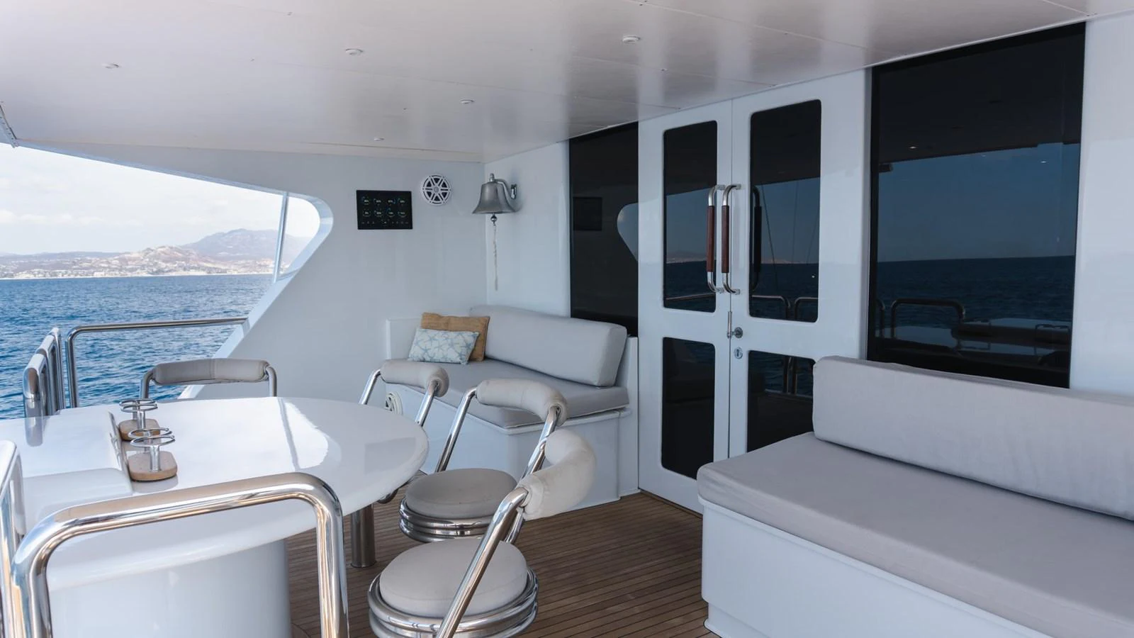 The aft deck features comfortable seating and a dining area with a view of the sea. aboard AUSSIE RULES Yacht for Sale