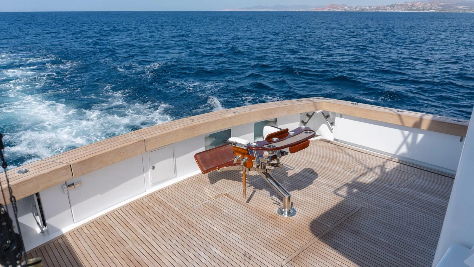 The aft deck features a fishing chair, perfect for deep-sea fishing adventures. aboard AUSSIE RULES Yacht for Sale