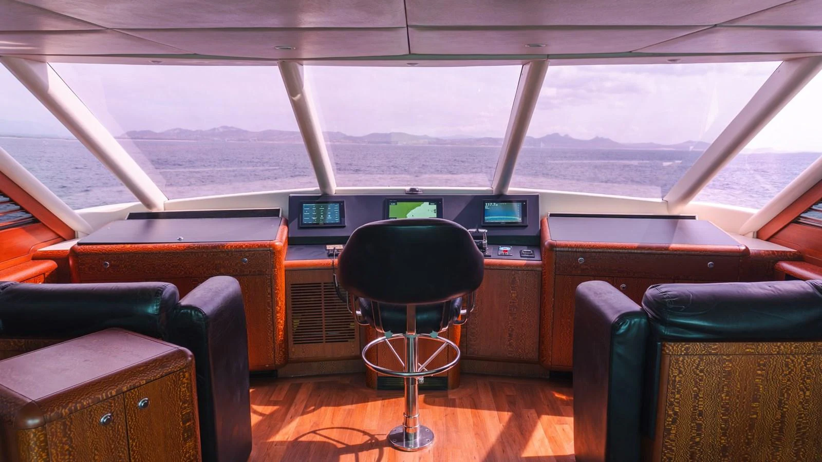 The helm station offers a commanding view with state-of-the-art navigation equipment and luxurious seating. aboard AUSSIE RULES Yacht for Sale