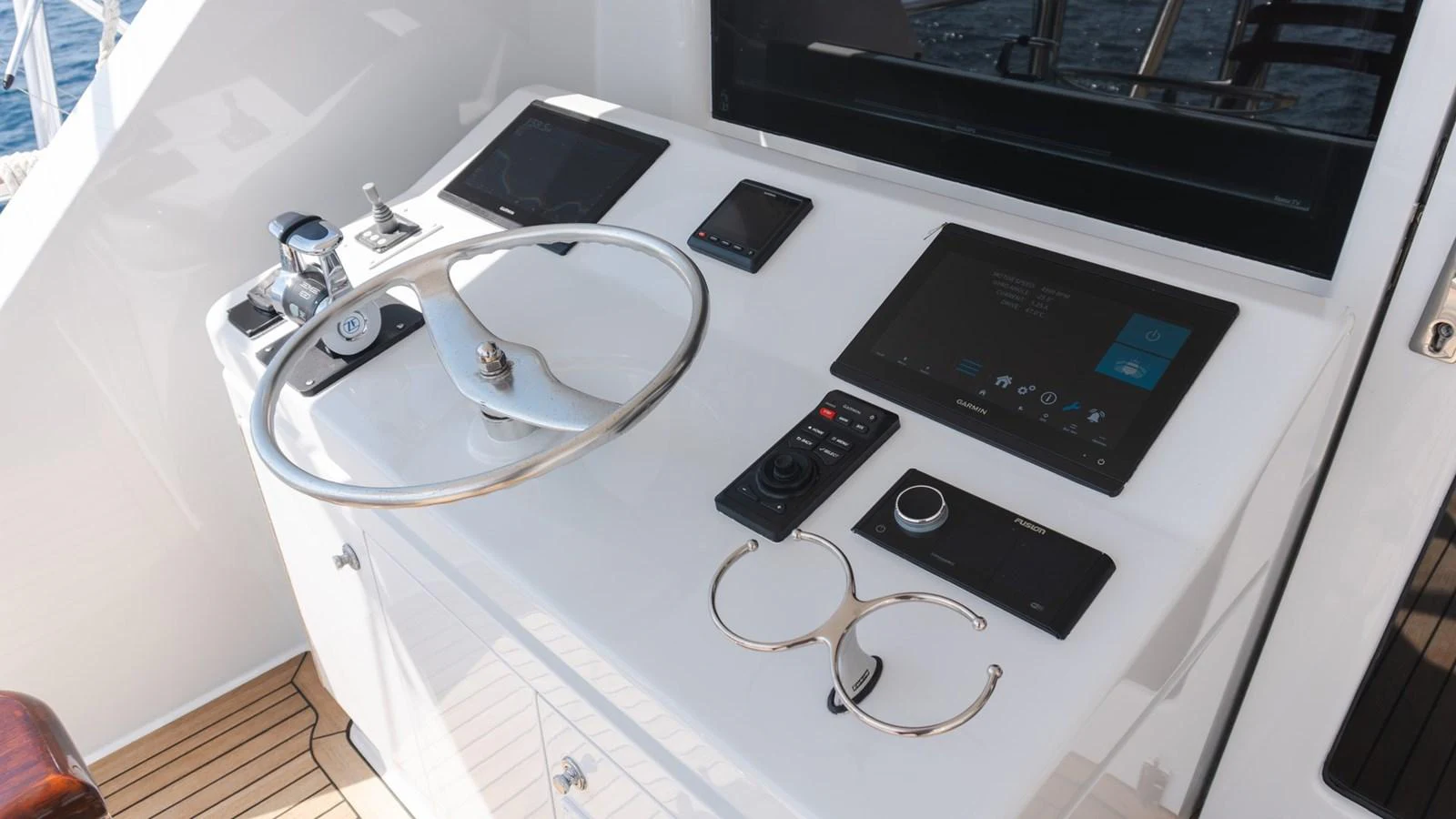 The helm station features modern navigation equipment and a sleek steering wheel. aboard AUSSIE RULES Yacht for Sale
