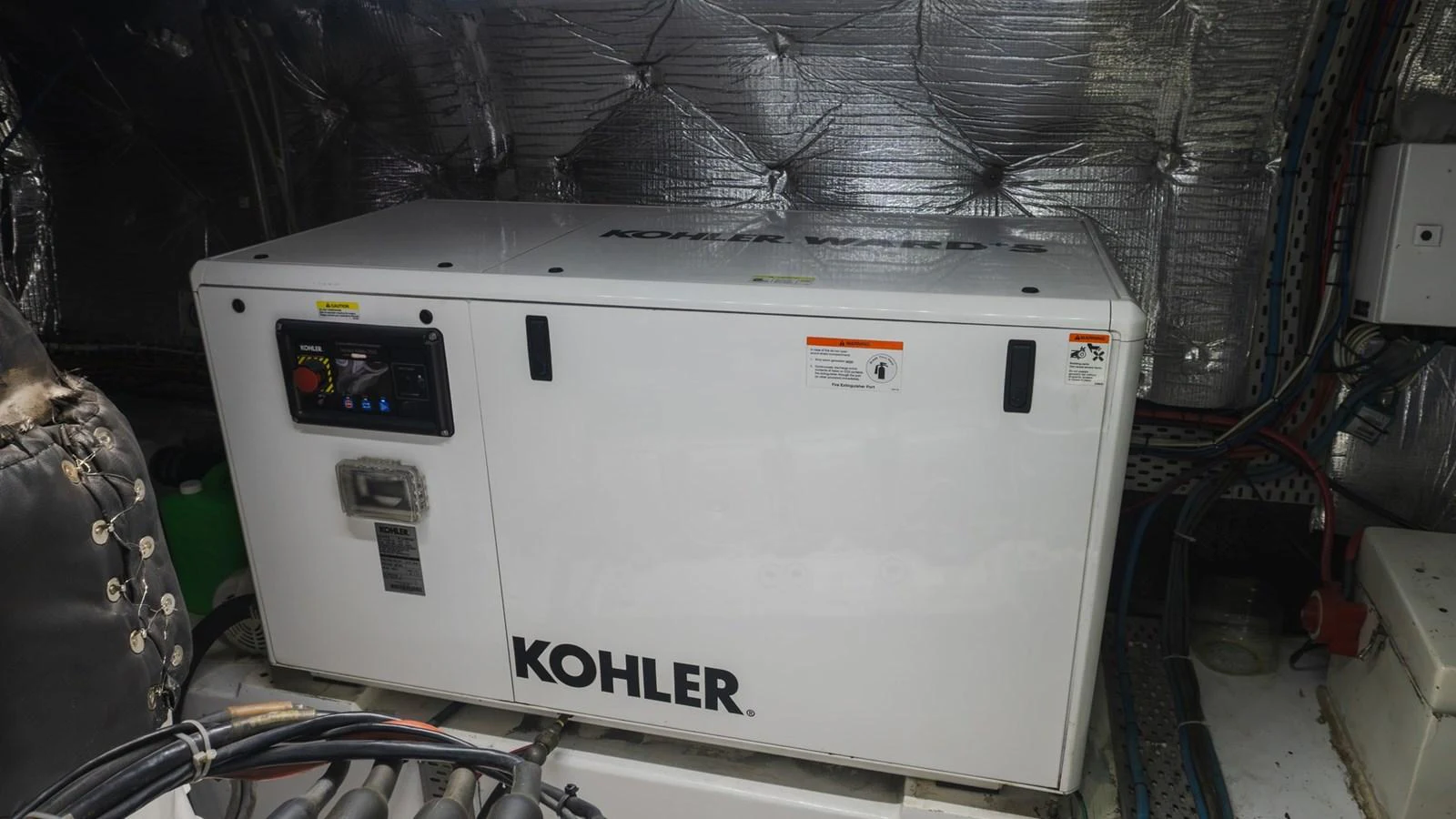 The image showcases a Kohler generator in the yacht's engine room, highlighting its technical equipment. aboard AUSSIE RULES Yacht for Sale