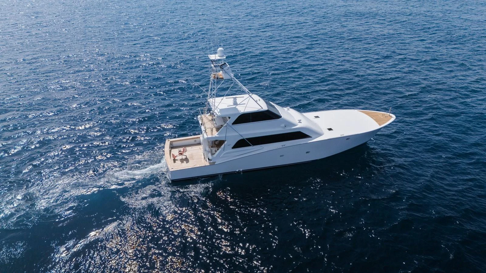 A sleek yacht cruises smoothly on the open water, showcasing its elegant design and spacious deck. aboard AUSSIE RULES Yacht for Sale