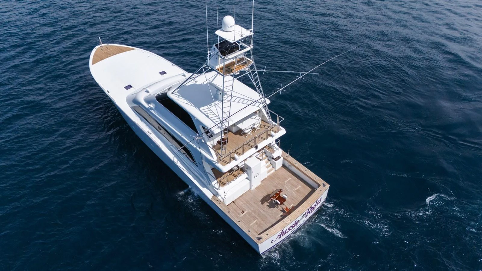 A sleek yacht cruises through the open water, showcasing its spacious deck and advanced fishing tower. aboard AUSSIE RULES Yacht for Sale
