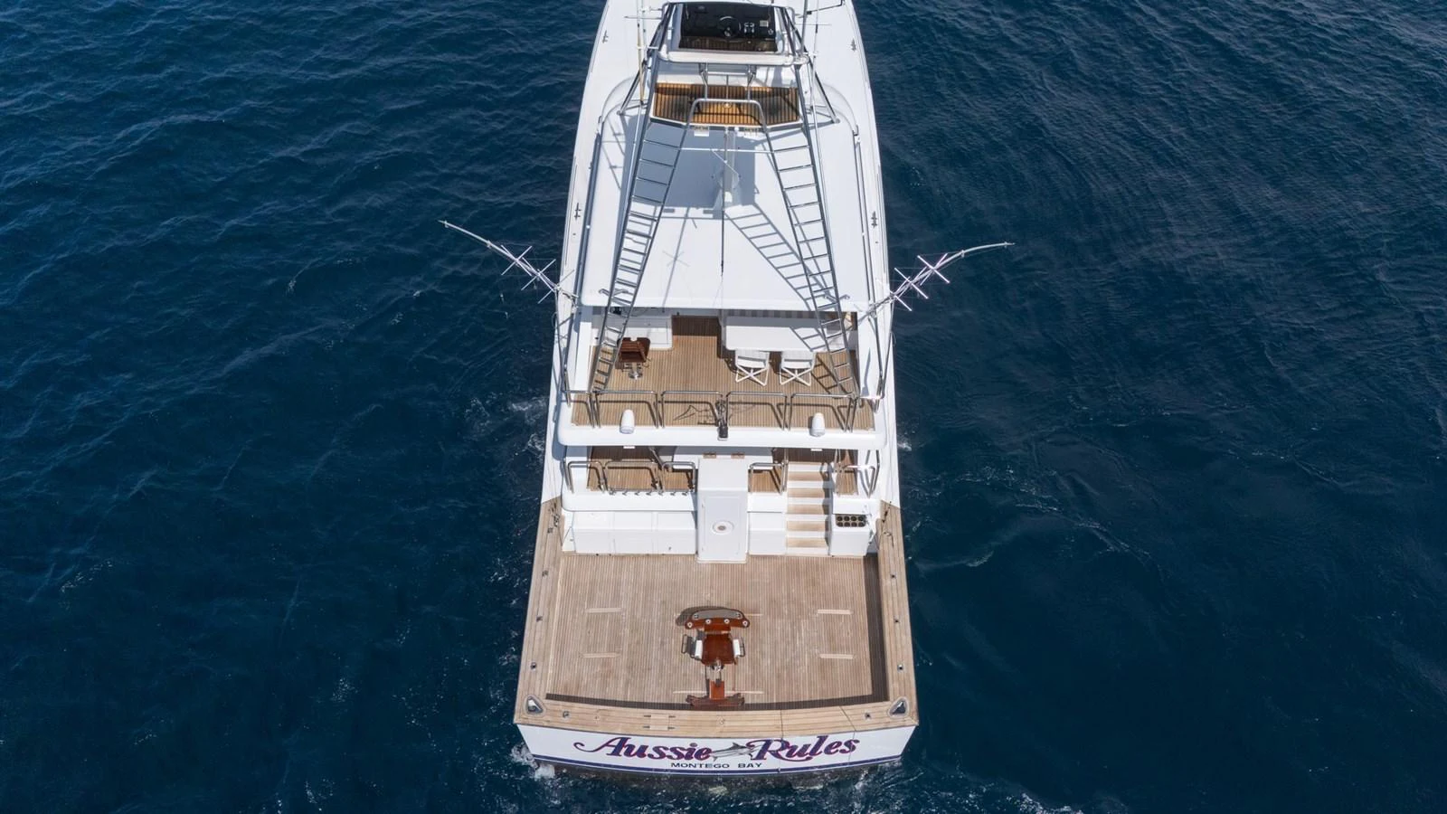 The yacht's aft deck is seen from above, showcasing a spacious area for relaxation and activities. aboard AUSSIE RULES Yacht for Sale