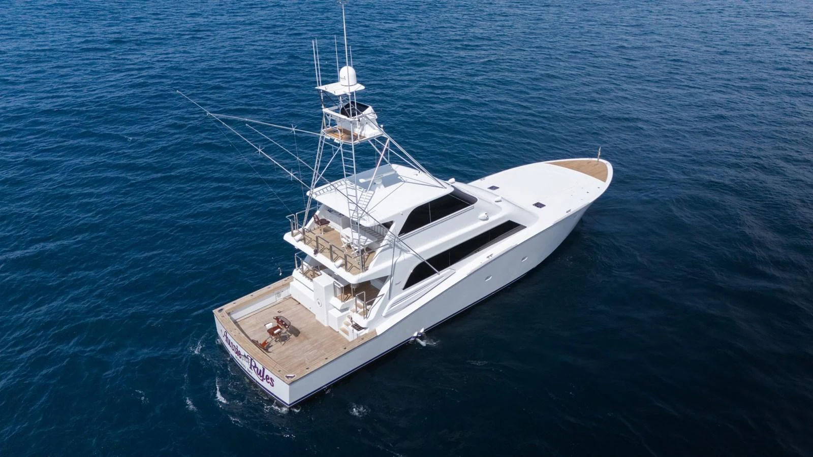 A sleek and modern yacht glides effortlessly over the deep blue sea. aboard AUSSIE RULES Yacht for Sale