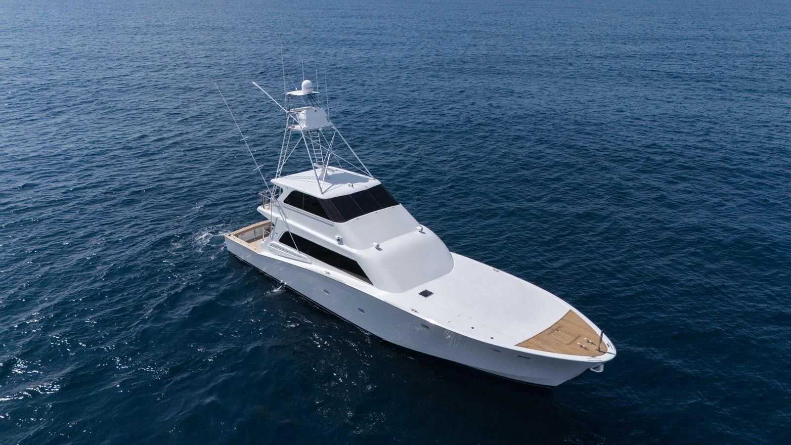 A sleek and modern yacht cruises gracefully on the open sea. aboard AUSSIE RULES Yacht for Sale