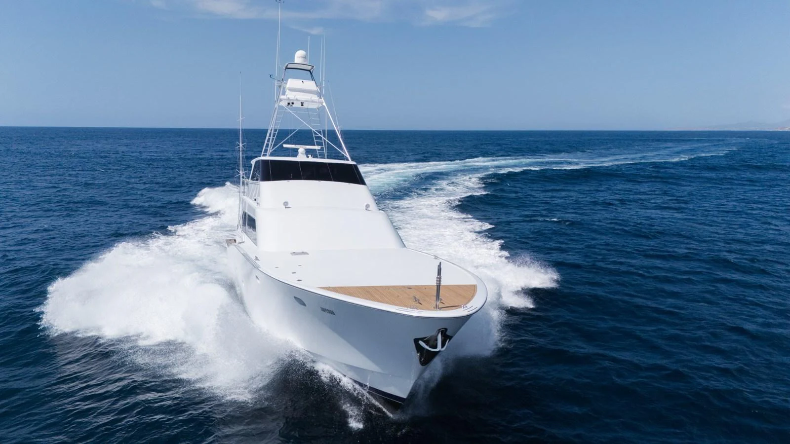 A sleek yacht cuts through the water, showcasing its powerful design and elegant lines. aboard AUSSIE RULES Yacht for Sale
