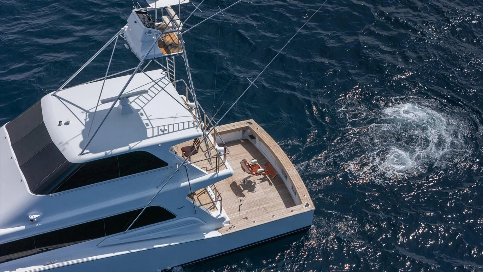 The yacht's aft deck offers a spacious area for relaxation and activities, with a stunning view of the surrounding water. aboard AUSSIE RULES Yacht for Sale