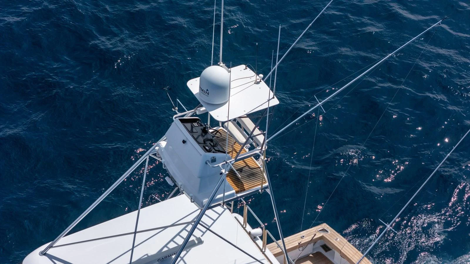 The image captures the flybridge of a yacht with its navigation equipment and antennas against the backdrop of the ocean. aboard AUSSIE RULES Yacht for Sale