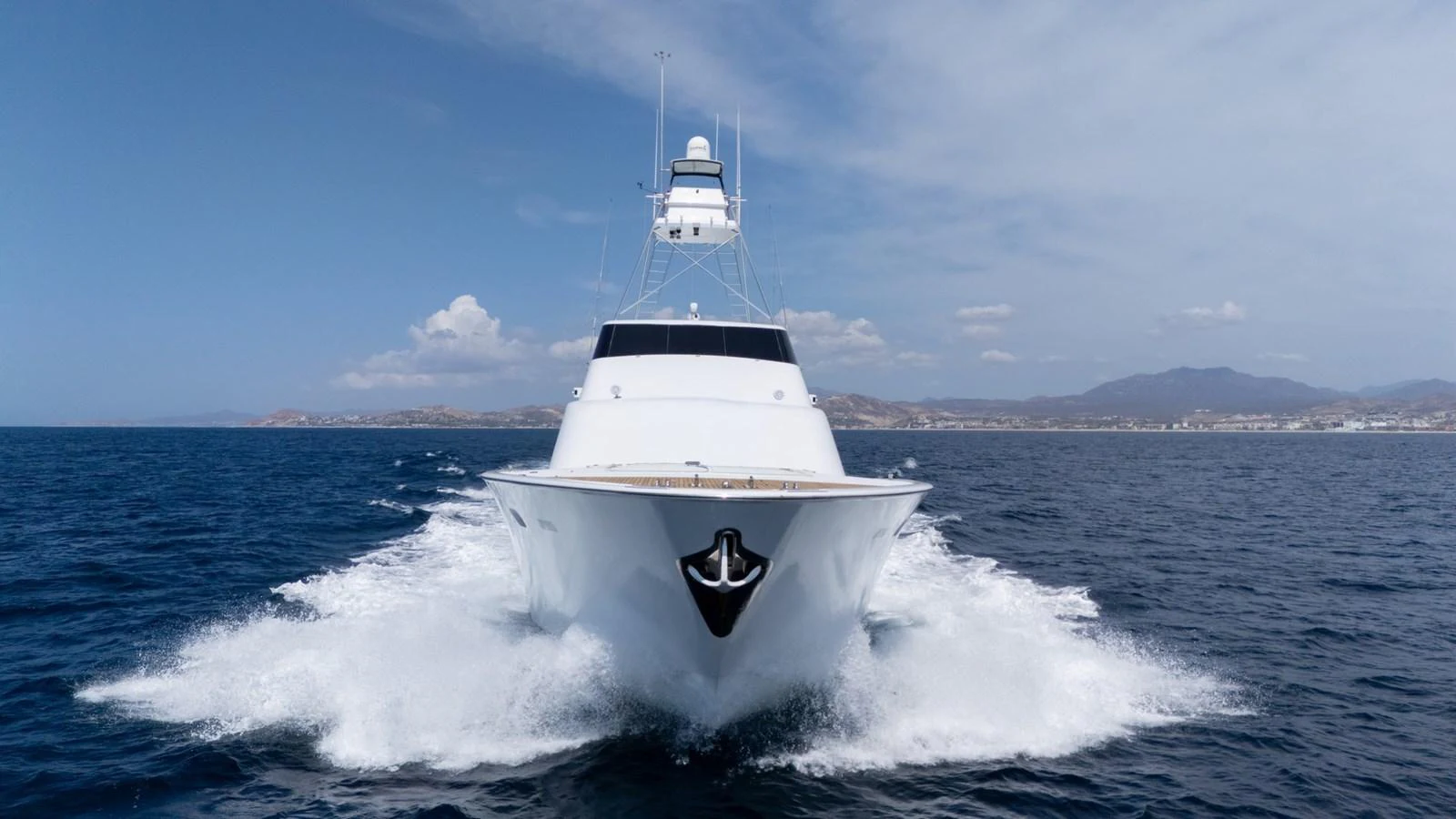 A sleek yacht cuts through the water, showcasing its powerful design and pristine condition. aboard AUSSIE RULES Yacht for Sale