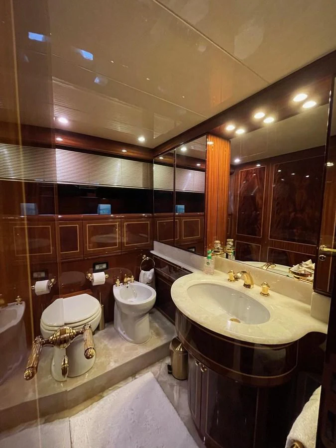 The yacht's bathroom features luxurious fixtures and elegant wood paneling. aboard AMAR T Yacht for Sale