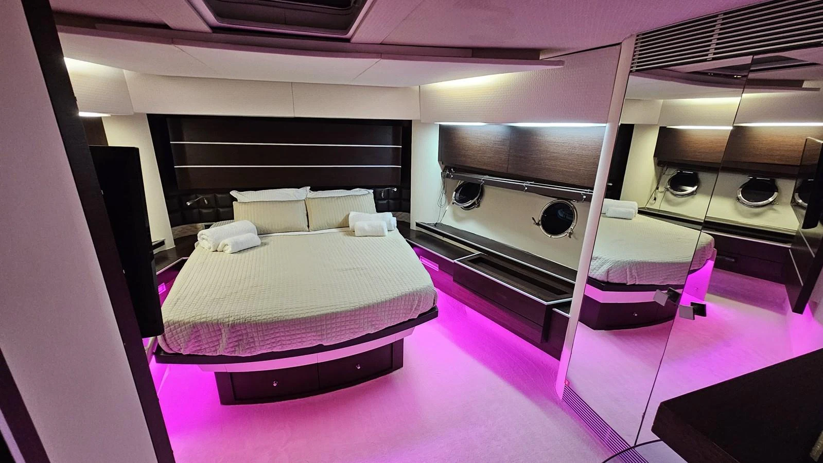 The stateroom features a luxurious bed with ambient lighting and modern decor. aboard AMAR T Yacht for Sale