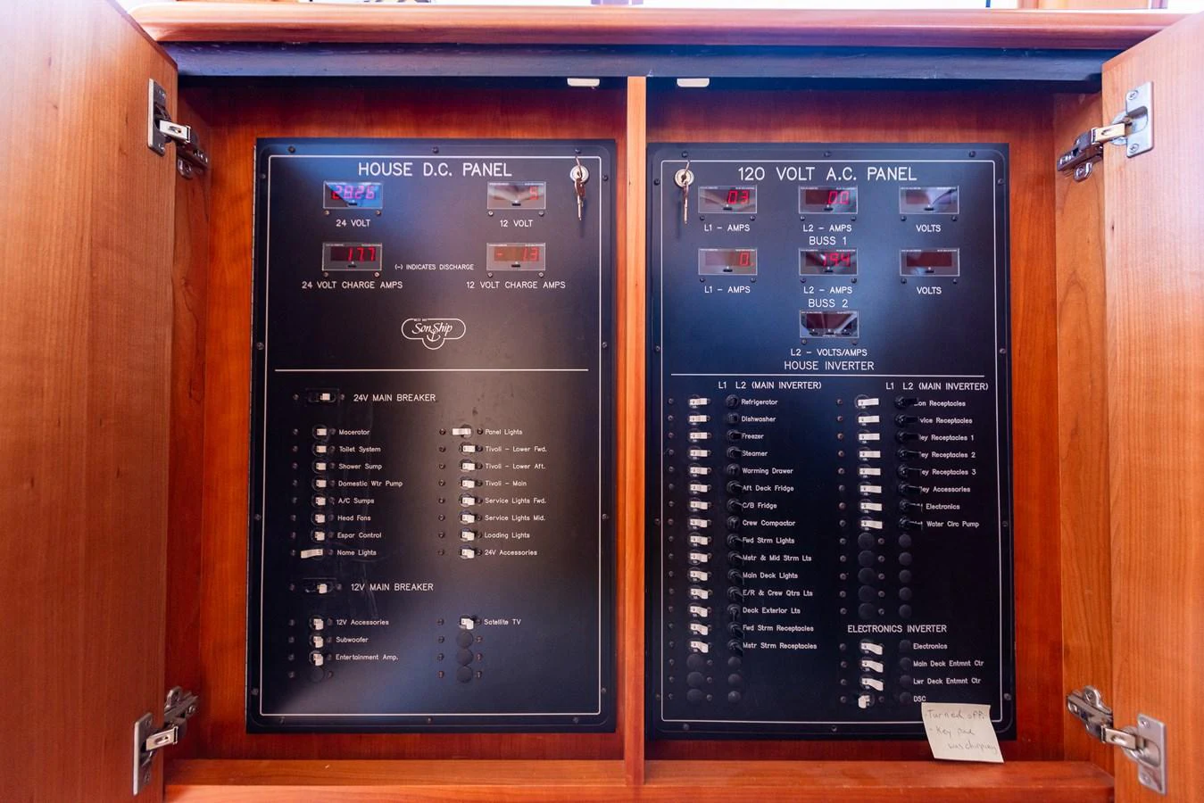 The yacht's electrical panel is neatly organized within a wooden cabinet. aboard DAWN TRADER VII Yacht for Sale