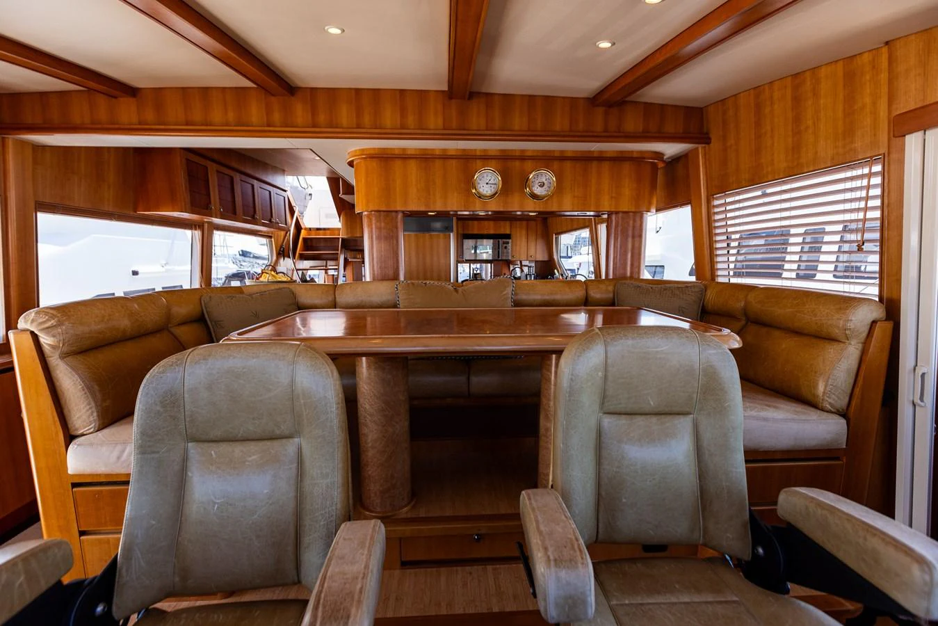 The yacht's dining area features plush seating and a beautifully crafted wooden table, creating an inviting space for meals. aboard DAWN TRADER VII Yacht for Sale